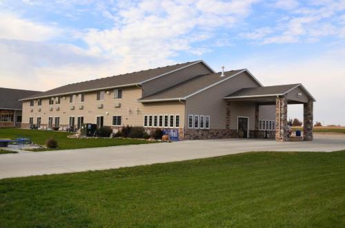 a large white building with a gazebo at Cobblestone Inn & Suites - Lake View in Lake View