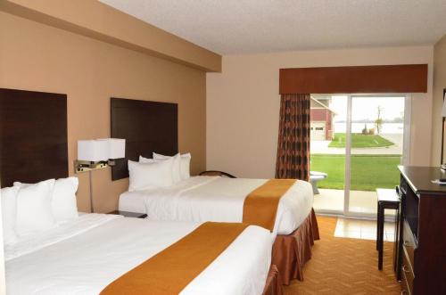 a hotel room with two beds and a television at Cobblestone Inn & Suites - Lake View in Lake View