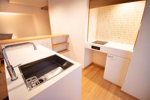 a small kitchen with a sink and a counter at The GrandWest Arashiyama in Kyoto