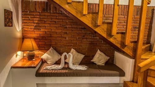 a bench with two white shoes sitting on it under a staircase at Suites Paraiso Tequis in Tequisquiapan