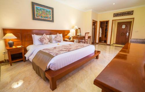 a bedroom with a large bed in a room at The Grand Bali Nusa Dua in Nusa Dua