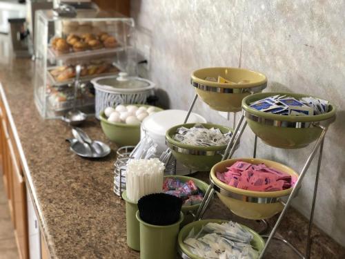 a kitchen counter with bowls and plates of food at Platte Valley Inn in Columbus