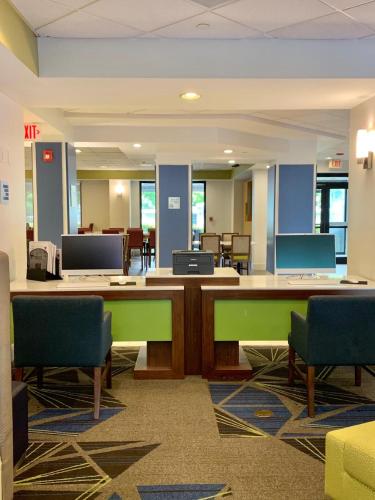 an office with a desk and chairs in a room at Holiday Inn Express Hotel & Suites Miami - Hialeah by IHG in Hialeah