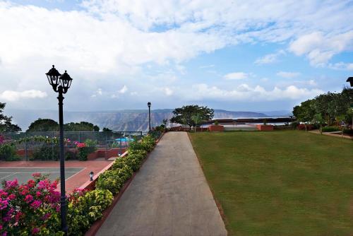 a park with a street light and flowers at Brightland Resort & Spa in Mahabaleshwar