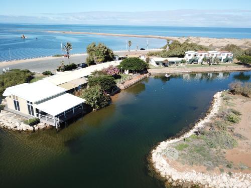 a large body of water surrounded by a fence at Carnarvon Beach Retreat in Carnarvon
