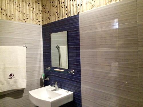 a bathroom with a sink and a mirror at Premier Inn Johar Town Lahore in Lahore