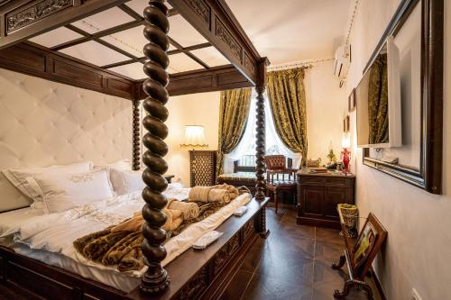 a bedroom with a canopy bed and a desk at USSR Apartment in Bucharest