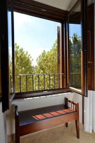 a window with a bench in a room with a view at Casa I Cappuccini in Rome
