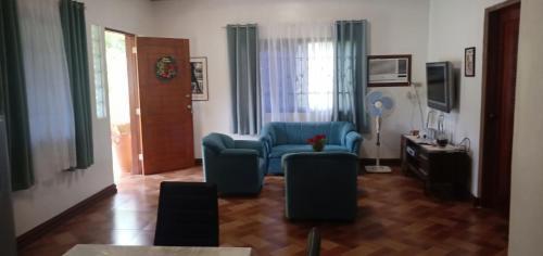 a living room with a blue chair and a table at E&N Paradise Island Resort in Siquijor