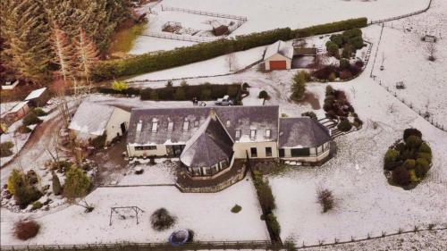 an aerial view of a house covered in snow at Belforte House Holiday Home in Inverness