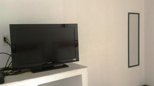 a flat screen tv sitting on top of a table at Hotel Maricarmen in Manzanillo