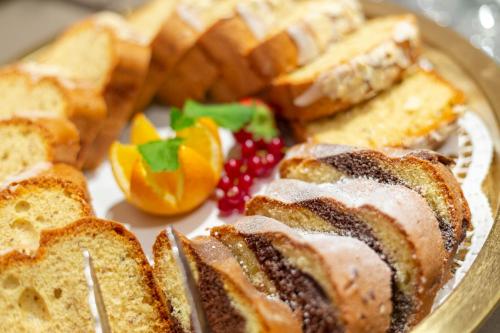 a plate of bread and fruit on a table at Hotel Goldried in Matrei in Osttirol