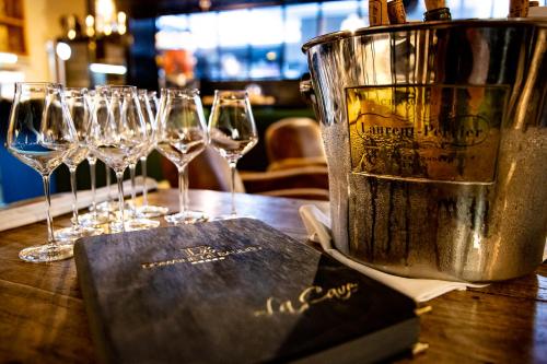 a table with wine glasses and a bucket on it at Le Domaine de Baulieu, Singuliers Hotels in Auch