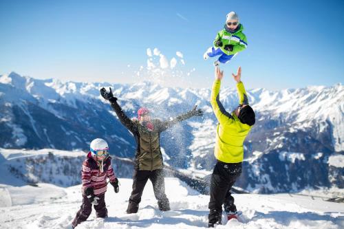 a group of people standing on top of a snow covered mountain at Hotel Goldried in Matrei in Osttirol