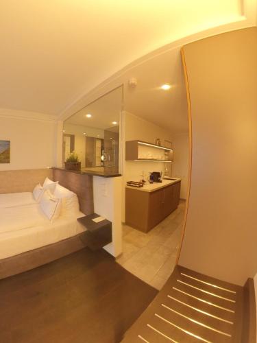 a bedroom with a bed and a bathroom with a sink at MeerBlickD21 in Norderney