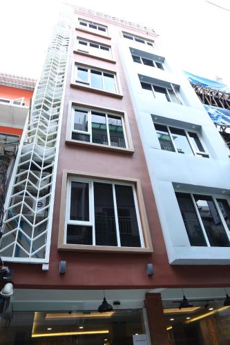 a tall building with many windows on it at Rose Nana Hotel in Bangkok