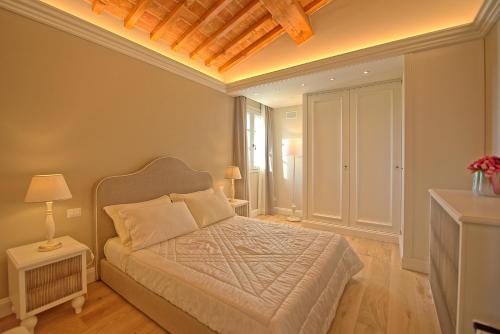 a bedroom with a bed with a wooden ceiling at Il Sole di Vino by PosarelliVillas in Vinci