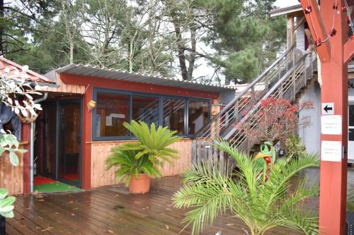a house with a staircase and plants on a deck at Chez Augustin in Lacanau-Océan
