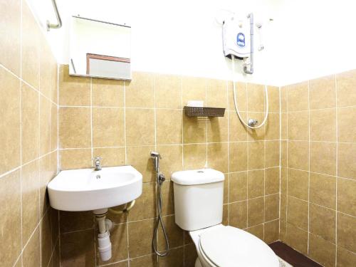 a bathroom with a toilet and a sink at OYO 89562 Hotel Shalimar in Kuala Lumpur