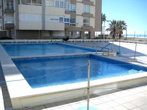 a large swimming pool in front of a building at A Nossa Casa da Costa in Costa da Caparica