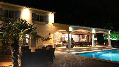 a house with a swimming pool at night at Les Geais - Marevalande in Sainte-Maxime