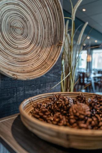a bowl of food sitting on a table with a coil at Hotell Storforsen in Bredsel