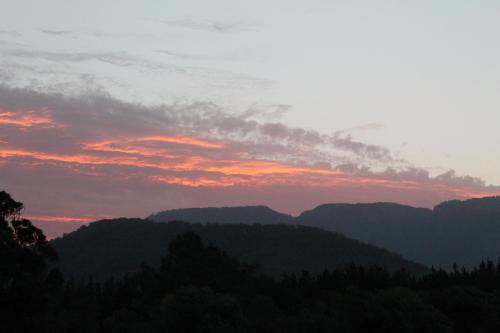 a sunset over the mountains in the hills at Buffalo Motel and Country Retreat in Porepunkah
