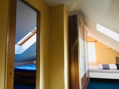 a room with a mirror and a bunk bed at Penzion Úpice Luky in Úpice