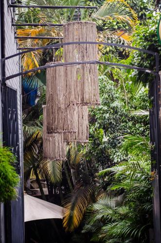 a basket hanging from the side of a building with plants at Hôtel Restaurant La Ribaudière in Antananarivo