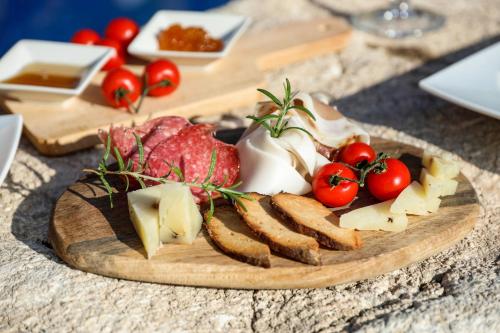 a plate of food with cheese and tomatoes on a table at Hotel Villa Sonia in Taormina
