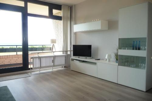 a living room with a television and a large window at Ferienresidenz-79-5 in Staberdorf