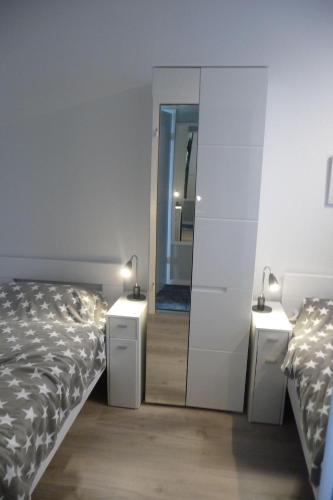 a bedroom with two beds and a mirror at Ferienresidenz-79-5 in Staberdorf