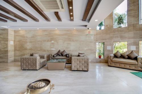 a large living room with couches and a table at Hotel Royale Palace in Mount Ābu
