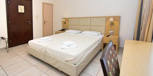 a bedroom with a bed with two towels on it at San Nectarios in Parga
