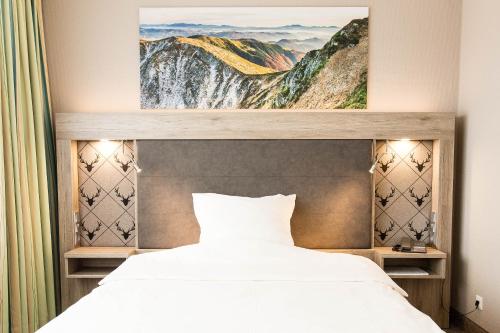 Säng eller sängar i ett rum på Hotel Bavaria Oldenburg