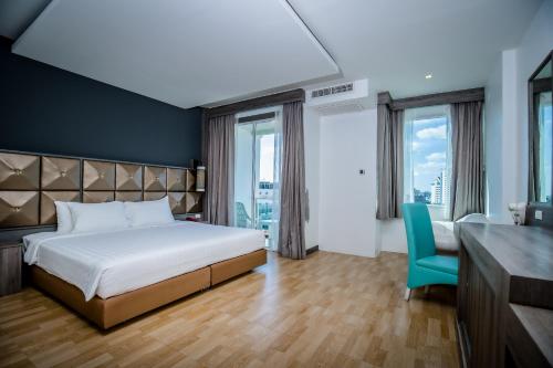 En eller flere senge i et værelse på Add Plus Hotel & SPA