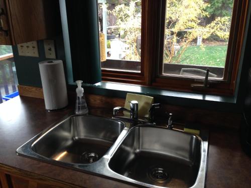 a stainless steel sink in a kitchen with a window at 3 Bedrooms 3 beds near metro -2 Parking Free in Montréal