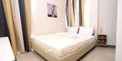 a bedroom with a bed with two towels on it at San Nectarios in Parga
