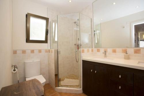 a bathroom with a shower and a toilet and a sink at Villa Pita - Deniasol in Denia