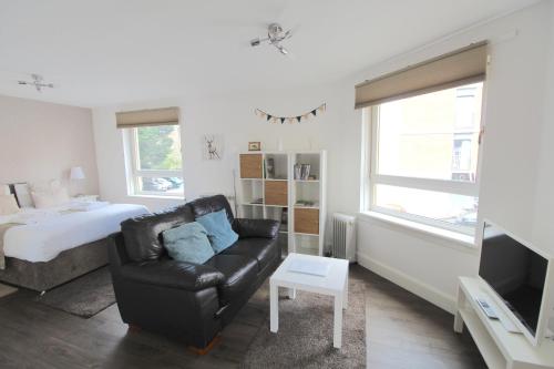 a living room with a couch and a bed at Lochrin Apartments by Edinburgh City Apartments in Edinburgh