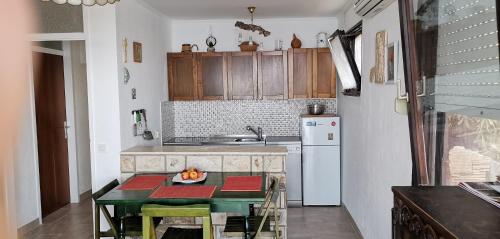 a kitchen with a table with a bowl of fruit on it at Holiday Home Prizba in Prizba