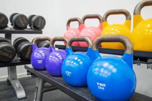 a row of dumbbells on a table in a gym at Thon Hotel Bergen Airport in Bergen