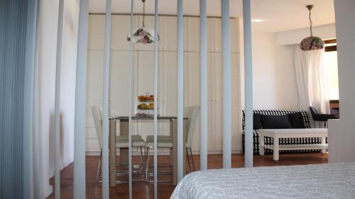a dining room with a table and a table and chairs at Marlenghi Apartments View Canteras in Las Palmas de Gran Canaria