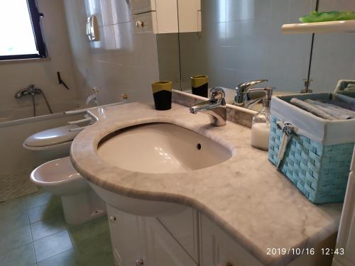 a bathroom with a sink and a toilet at Sweet house in Bari