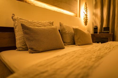 a bedroom with a bed with pillows on it at Locanda Boutique Hotel in Stollberg