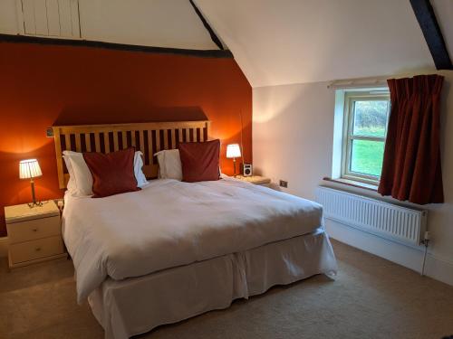 a bedroom with a large bed and a window at Elderbrook House in Avebury