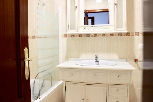a bathroom with a white sink and a shower at City CENTER and Free PARKING apartment in Jerez de la Frontera
