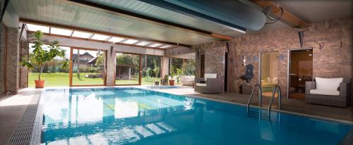a swimming pool in a house at Alzbeta resort - Aqua & Wellness in Liptovský Mikuláš