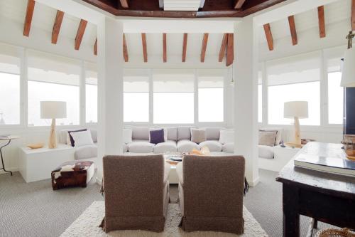 a living room with white furniture and large windows at Dossau by FeelFree Rentals in Naut Aran