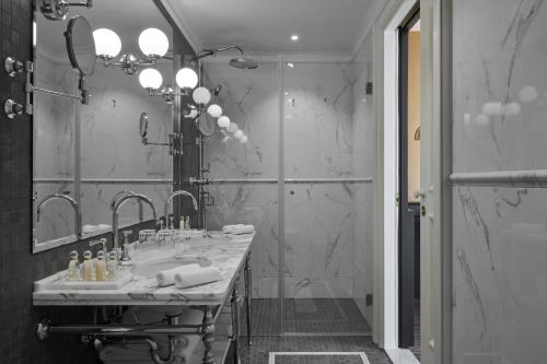 a bathroom with a large sink and a shower at Palace Elisabeth Hvar Hotel - The Leading Hotels of the World in Hvar